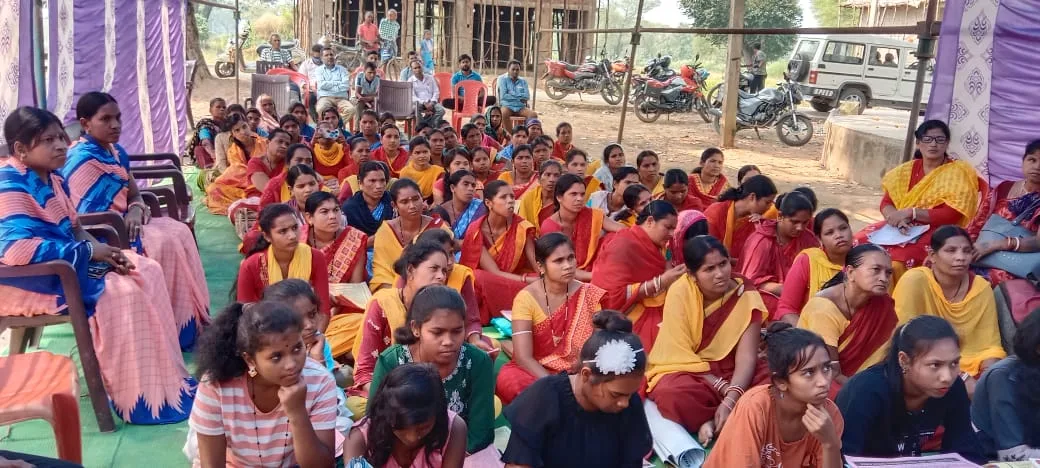 Women and young people seated together at a community gathering