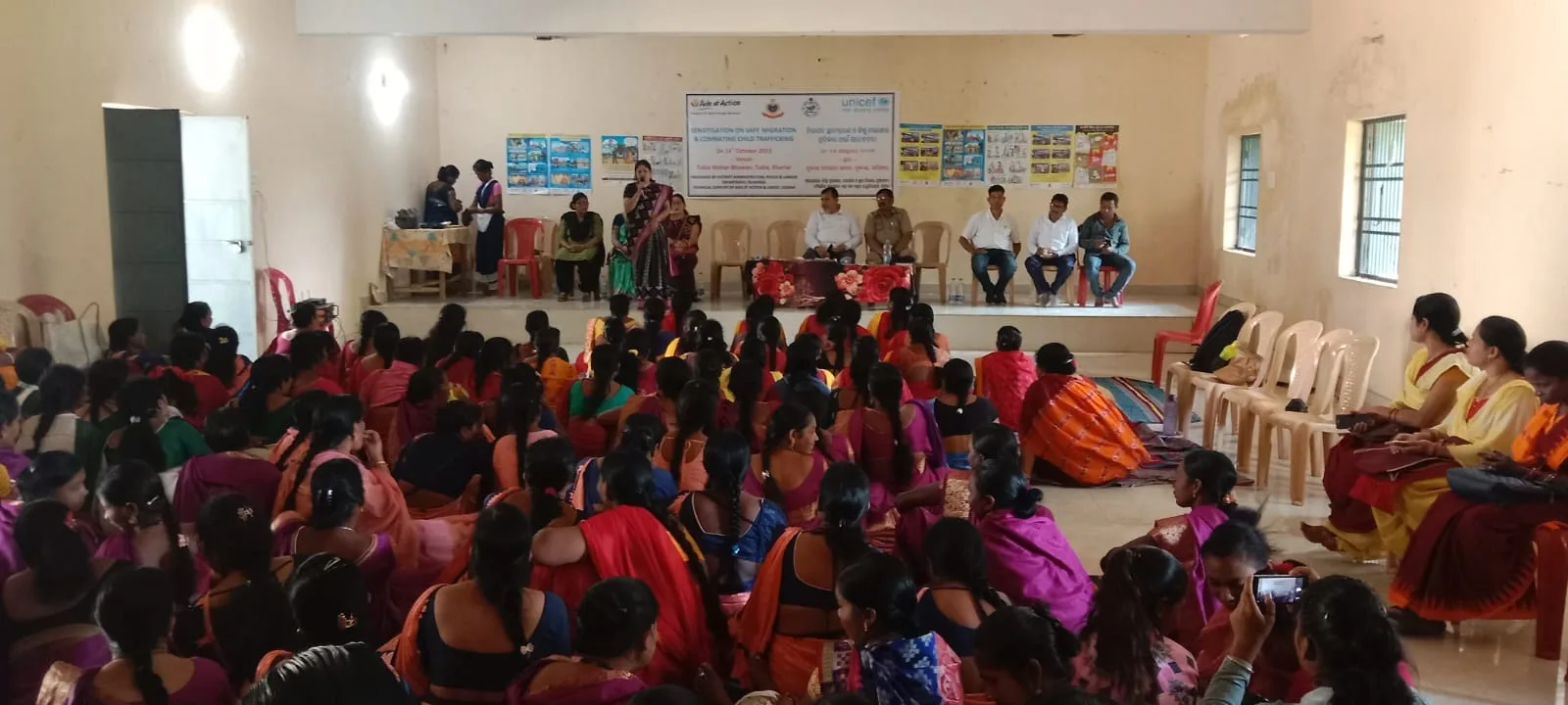 Large community group attending a safe migration and anti-trafficking sensitization session